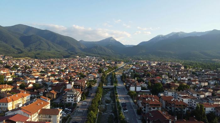 Mountain town beneath forested peaks in southern Bulgaria