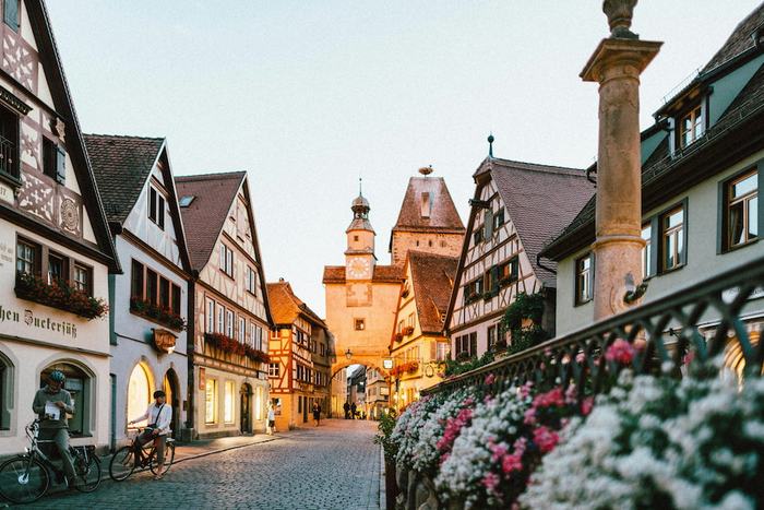 Half-timbered houses and a clock tower on a cobbled street in Rothenburg ob der Tauber